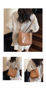 Detail view of a vintage brown bucket bag showing the matte PU leather texture and pocket