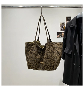 Detail of leopard print canvas tote bag with our fave label hanging on a rack
