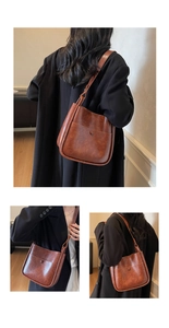 Detail view of vintage brown leather bucket bag with large capacity and buckle pocket