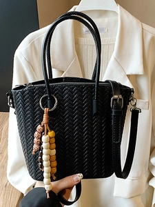 Chic black woven bucket bag with V-pattern texture and colorful bead charm accessory