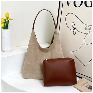Detailed close-up of a beige suede hobo bag with a brown leather pouch and strap