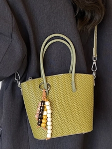 Grass green woven bucket bag with long strap and decorative wooden beads for women