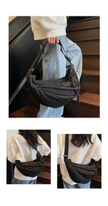 Detail of black nylon crescent bag featuring stylish pleated stitching and adjustable strap