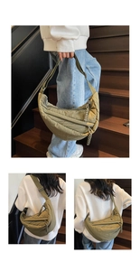 Detail showing an olive green quilted crossbody bag with adjustable wide fabric strap