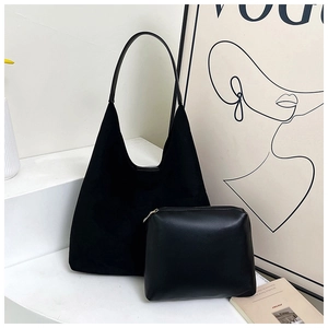 Detail of black tote bag set with textured finish and matching zipper pouch for women