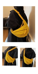 Close-up of ginger yellow nylon crossbody bag with woven zipper pull and adjustable strap