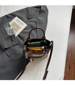 Spacious interior of canvas and leather bucket bag with phone and wallet inside