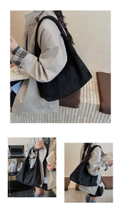 Gros plan du sac cabas en toile noire avec fleurs ajourées et large bandoulière confort