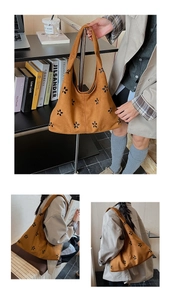 Détail du sac cabas en daim marron vintage avec motifs floraux découpés au laser et spacieux