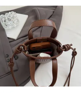 Top-down view of the brown leather mini bucket bag showing spacious interior compartment