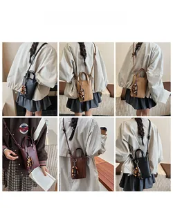 Vertical mini crossbody bags in various colors with decorative wooden bead tassels