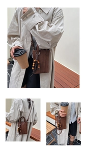 Brown woven mini crossbody phone bag featuring decorative wooden bead tassels for women