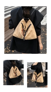City street view showing large khaki suede tote bag used as both backpack and shoulder bag