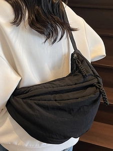 Japanese style black crescent crossbody bag made of durable nylon with woven zipper puller