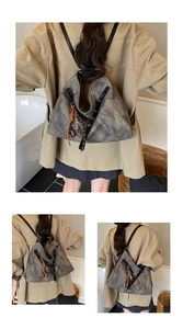 Detail of vintage grey tote bag showing textured matte finish and Victoria metal charm
