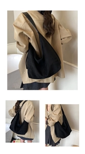Detailed close-up showing the large capacity black hobo bag in soft matte canvas fabric