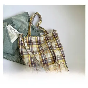 Detail of yellow and purple plaid canvas tote bag with Yes Honey letter print