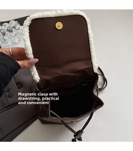 Brown faux leather backpack detail showing magnetic snap closure and internal drawstring