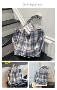 Detail of blue and orange plaid tote bag with Yes Honey embroidery and long shoulder straps