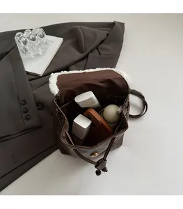 Detailed view of the spacious inner compartment showing phone and cosmetics storage