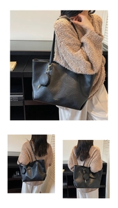 Detail of black tote bag with lychee texture and detachable round coin purse coin bag