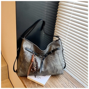 Detailed view of large vintage tote bag in distressed gray faux leather with retro charms