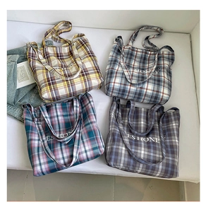 Four colors of plaid canvas tote bags with YES HONEY print and dual straps