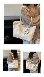Detail of white large capacity tote bag with smooth faux leather texture and round mini pouch