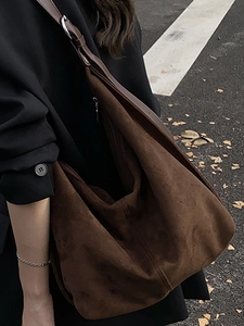 Minimalist large brown hobo tote bag in suede texture with adjustable shoulder strap