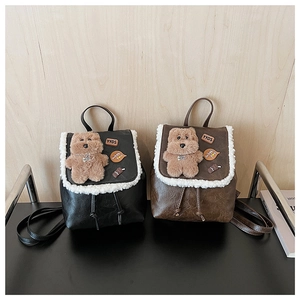 Detail view of mini backpacks with plush bears and embroidery on textured PU leather