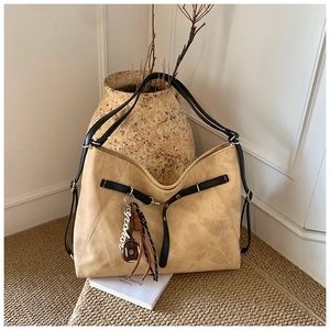 Detail of khaki hobo tote bag with retro matte texture and black contrast shoulder strap