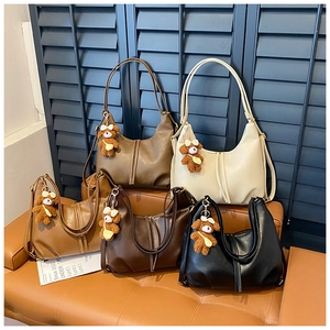 Collection of five vintage hobo bags in assorted neutral tones with cute bear charms