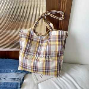Detail of checkered tote bag with Yes Honey embroidery and large capacity canvas