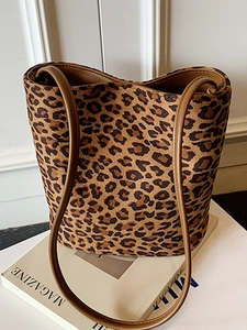 Fashionable leopard print bucket bag with brown leather straps and spacious interior