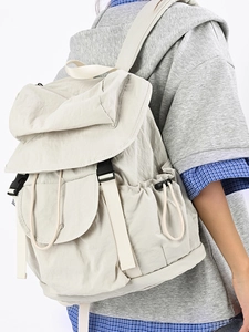 Minimalist beige travel backpack with flap closure and adjustable buckle for students