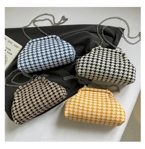 Macro shot of stylish houndstooth pattern handbags with metal chains in four colors