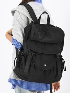 Minimalist black travel backpack in durable nylon with spacious compartments for students