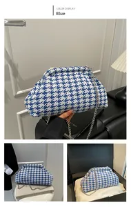 Detailed view of the blue houndstooth cloud bag with silver metal chain and woven fabric