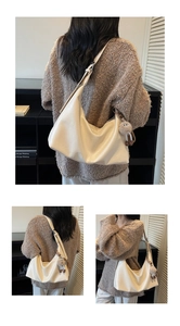 Detail view of cream white PU leather tote bag with stylish cartoon plush pendant accessory