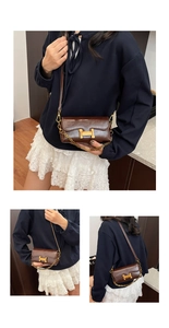 Détail d'un sac à main en cuir verni marron avec boucle en H dorée et bandoulière