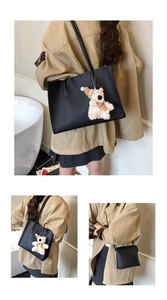 Detail of black lychee grain leather tote and mini bag set with cute bear charm