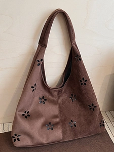 Brown suede hobo tote bag featuring laser-cut floral patterns and a vintage boho design