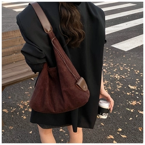 Détails du sac hobo en daim marron foncé montrant la texture douce et le rembourrage