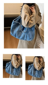 Detailed view of the denim tote bag featuring embroidered rings and chain straps