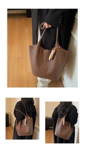 Detail of brown woven leather tote bag with decorative colorful beaded tassel charm