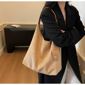 Detail of tan suede oversized hobo bag with matching mini pouch and seamless shoulder strap