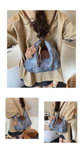 Detail view of denim tote bag with brown leather flap and cute plush bear accessory