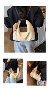 Detailed view of beige hobo bag with brown flap and detachable plush bear charm