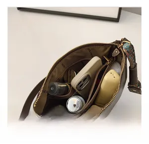 Internal view showing compartments and storage capacity of the brown bucket bag