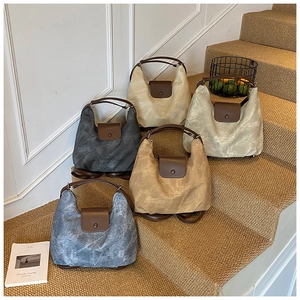 Detail showing five colors of textured tote bags on steps highlighting the marbled fabric